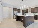 Spacious kitchen featuring a large island, stainless steel appliances, and modern finishes at 9544 Mere Pkwy, Orlando, FL 32832