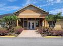 Exterior view of the community clubhouse entrance with manicured landscaping and ample parking at 9903 Turf Way # 4, Orlando, FL 32837