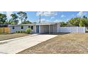 Charming single-story home featuring a well-manicured lawn, blue door, and a convenient carport at 994 Lormann Cir, Longwood, FL 32750