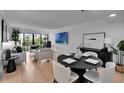 Bright living room featuring hardwood floors, neutral colors, and a sliding glass door to a private balcony at 100 S Interlachen Ave # 410F, Winter Park, FL 32789