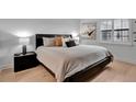 Calm main bedroom featuring a platform bed, neutral tones, natural light, and hardwood floors at 100 S Interlachen Ave # 410F, Winter Park, FL 32789