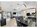 Open concept layout showcasing living room, dining area, and kitchen with modern appliances at 10049 Custer Cir, Orlando, FL 32817