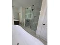 Modern bathroom boasts a freestanding tub and glass enclosed shower with tiled surround at 1005 Randall St, Orlando, FL 32805