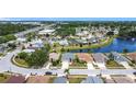 A beautiful aerial view of a residential area near a serene lake on a sunny day with clear blue skies at 1021 Whalebone Bay Dr, Kissimmee, FL 34741