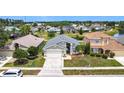 Aerial view of home with lush landscaping and lake view; a beautiful home in a desirable neighborhood at 1021 Whalebone Bay Dr, Kissimmee, FL 34741