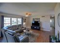 Spacious living room with hardwood floors, ample natural light, and comfortable leather furniture at 11137 Acme Dr # 207A, Orlando, FL 32825