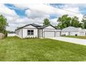 Beautiful one-story home with gray trim, two-car garage, and a green lawn at 13312 Sw 41St Ct, Ocala, FL 34473