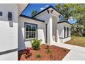 Close-up view of the front door showcasing clean architecture and low maintenance landscaping at 13430 Sw 88Th Ter, Ocala, FL 34473