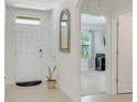Bright foyer with tile flooring, leading to an open-concept layout with modern finishes and natural light at 1535 Barberry Dr, Kissimmee, FL 34744