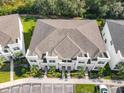 Birds eye view of townhome complex with parking, lush lawn and manicured landscaping at 17230 Blessing Dr, Clermont, FL 34714