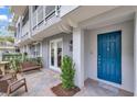 Charming exterior of a light gray townhome with a white fence and vibrant blue door at 1767 Piedmont Pl, Lake Mary, FL 32746