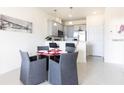 Open concept kitchen and dining area, perfect for entertaining, with stylish gray chairs at 1798 Coriander Dr, Kissimmee, FL 34759