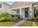Inviting home showcasing a blue door, brick pathway, and well-maintained greenery at 17985 Adrift Rd, Winter Garden, FL 34787