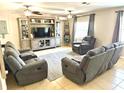 Spacious living room featuring tile floors, ceiling fans, and a neutral color scheme perfect for relaxation at 213 S Lake Pleasant Rd, Apopka, FL 32703