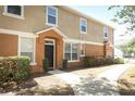 Front exterior of a two-story townhouse with an orange and beige color scheme at 2530 San Jacinto Cir # 2530, Sanford, FL 32771