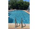 Sparkling community pool with lounge chairs for relaxation on a sunny day at 2530 San Jacinto Cir # 2530, Sanford, FL 32771