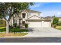 Charming two-story home with a three car garage and well-manicured lawn and landscaping at 2704 Gorst Rd, Winter Garden, FL 34787