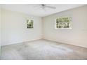 Comfortable bedroom featuring neutral walls, carpeted flooring, and ample natural light at 36208 Micro Racetrack Rd, Fruitland Park, FL 34731