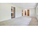 Open-concept living room with doorways and neutral carpet at 36208 Micro Racetrack Rd, Fruitland Park, FL 34731