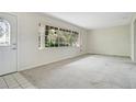 Bright living room with large window and neutral carpet flooring at 36208 Micro Racetrack Rd, Fruitland Park, FL 34731