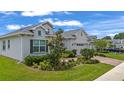 Lovely home showcasing lush landscaping, a brick driveway, and an attached two-car garage in a serene neighborhood at 4296 Mirror Ct, Clermont, FL 34714