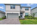 Charming two-story home with a manicured lawn, beautiful landscaping and gray siding at 4336 Foggy Oak Ln, Sanford, FL 32773