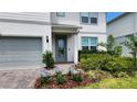 Close up of a home's front entrance featuring a glass door and well-maintained landscaping at 4336 Foggy Oak Ln, Sanford, FL 32773