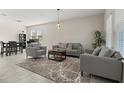 Spacious living area with tile flooring, modern decor, and a cozy seating arrangement at 4350 Verde Valley Ln, Kissimmee, FL 34746