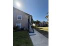 Low angle shows building exterior and access stairs to 2nd floor units at 4772 Walden Cir # 228, Orlando, FL 32811