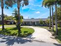 Lovely single-story home featuring a well-maintained lawn and inviting circular driveway at 5100 La Croix Ave, Belle Isle, FL 32812