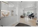Bright foyer with a grand piano and elegant finishes, leading into a spacious living area with water views at 5550 Osprey Isle Ln, Orlando, FL 32819