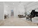 An expansive living room with tray ceilings, tile flooring and a view to the grand staircase at 5550 Osprey Isle Ln, Orlando, FL 32819