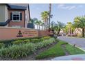 Entrance to the Fountains at Metro West community, featuring lush landscaping and a decorative sign at 5953 Westgate Dr # 1823, Orlando, FL 32835