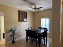 Cozy dining room featuring tile flooring, a modern ceiling fan, and a six-seat dining table at 708 Pincon Ln, Kissimmee, FL 34759
