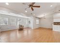 Bright, open living area with hardwood floors, recessed lighting, ceiling fan, and large windows at 7333 Radiant Cir, Orlando, FL 32810