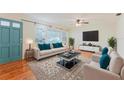 Bright living room featuring hardwood floors, large windows, and stylish contemporary furnishings at 735 Baltimore Dr, Orlando, FL 32810