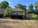 Side exterior view of home featuring well-maintained landscaping and clear windows at 840 Lake Jackson Cir, Apopka, FL 32703