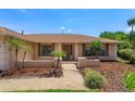 Beautiful single-story home featuring manicured landscaping with shrubbery and young palms at 8702 Master Link Ct, Orlando, FL 32836