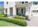 Inviting front porch features stone accents, comfortable seating, and lush landscaping for curb appeal at 8768 Sonoma Coast Dr, Winter Garden, FL 34787