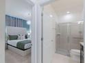 View of a bedroom with stylish ensuite bathroom featuring a glass-enclosed shower at 880 Paradise Dr, Davenport, FL 33897