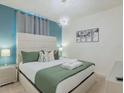 Beautiful bedroom featuring modern lighting fixtures and neutral decor at 880 Paradise Dr, Davenport, FL 33897