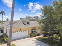 Inviting home with a two-car garage, well-maintained lawn, and a welcoming entrance at 13241 Fountainbleau Dr, Clermont, FL 34711