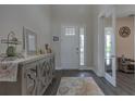 Bright foyer featuring wood flooring, decorative rug, console table, and views of the home's interior at 3302 Stonegate Dr, Ocoee, FL 34761