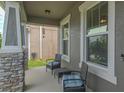 Cozy covered front porch with stone columns, comfortable seating, and space to relax outdoors at 3302 Stonegate Dr, Ocoee, FL 34761