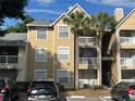 Multi-Gathering exterior showcases a tan color scheme, complemented by white trim and multiple parking spaces at 1065 S Hiawassee Rd # 1434, Orlando, FL 32835