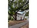 Street view of a charming home with mature trees and a landscaped yard at 111 E 8Th St, Sanford, FL 32771