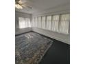 Bright living room with large windows, fresh paint and a modern ceiling fan at 111 E 8Th St, Sanford, FL 32771