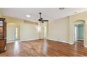 Spacious living room with hardwood floors and arched doorways allows for seamless flow throughout the home at 1156 Brandy Lake View Cir, Winter Garden, FL 34787