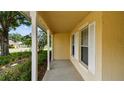 Inviting covered porch featuring classic columns and windows, perfect for enjoying the outdoors in comfort at 1156 Brandy Lake View Cir, Winter Garden, FL 34787