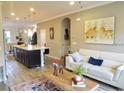 Open-concept living room with lots of natural light, flowing into kitchen and dining areas at 11746 Water Run Aly, Windermere, FL 34786